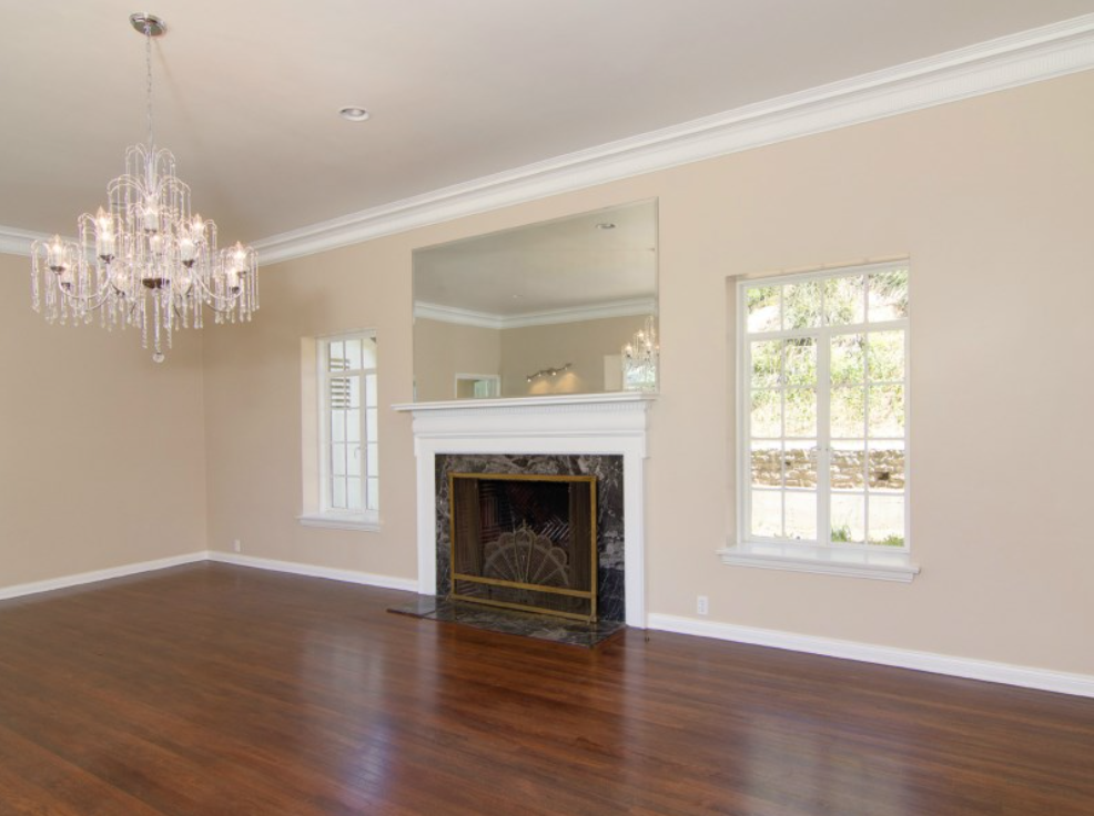 The home has an open layout with espresso-toned floors, fireplaces and ample light.