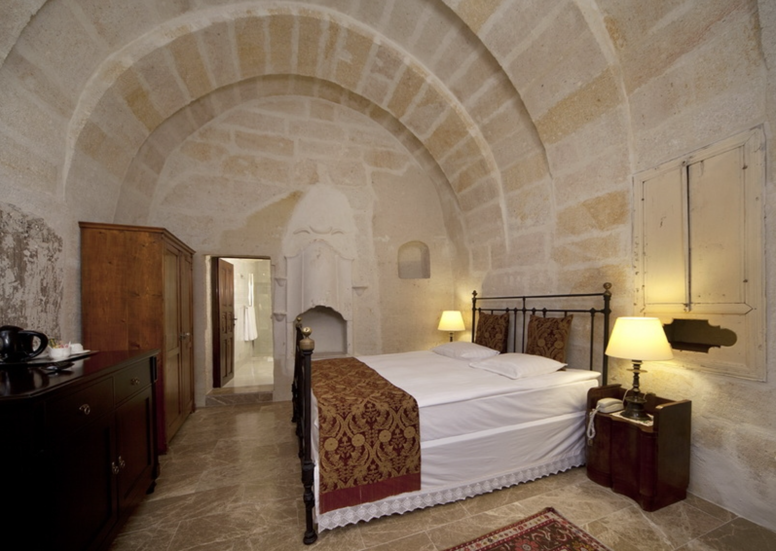 Bedroom suite with high naturally arched marble ceilings.